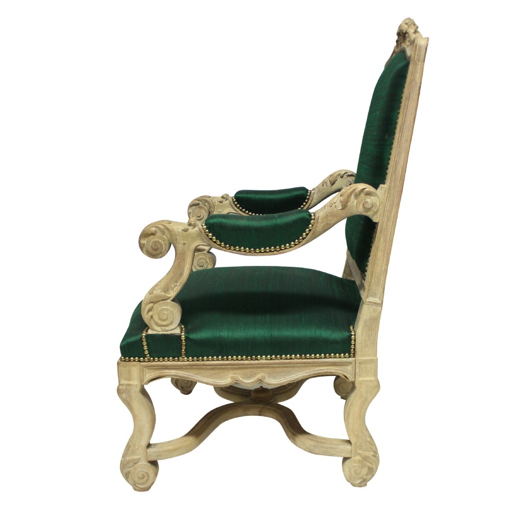 A Louis XIV style carved wood armchair upholstered in vibrant emerald green silk with brass stud details. View V