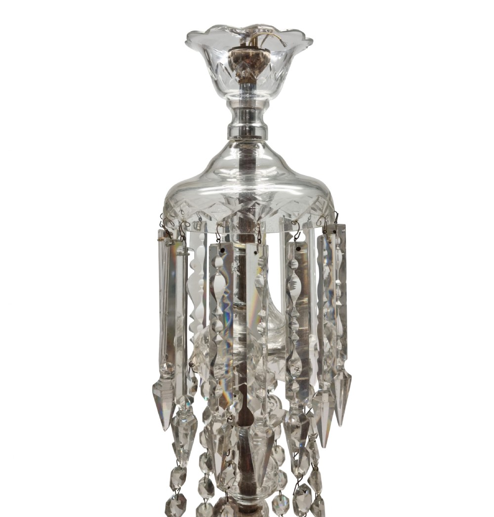 An English twelve-light cut glass chandelier featuring tiered glass arms, faceted crystal drops, and cascading bead swags. View V