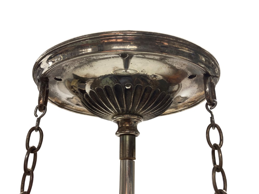 An Edwardian clear cut glass pendant light featuring a diamond-patterned acorn shade suspended by metal chains and a central rod from a fluted ceiling rose. View IV