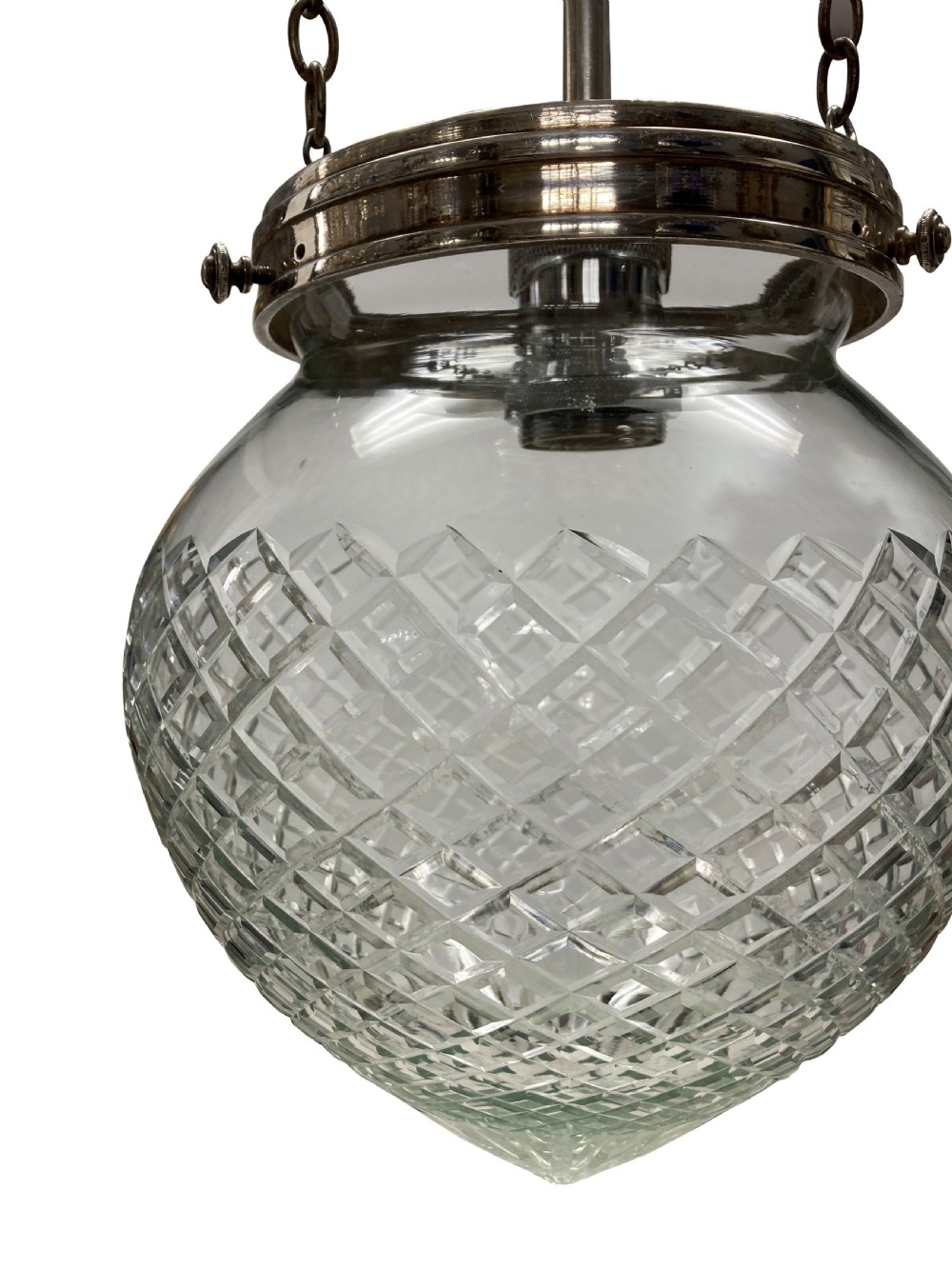 An Edwardian clear cut glass pendant light featuring a diamond-patterned acorn shade suspended by metal chains and a central rod from a fluted ceiling rose. View V