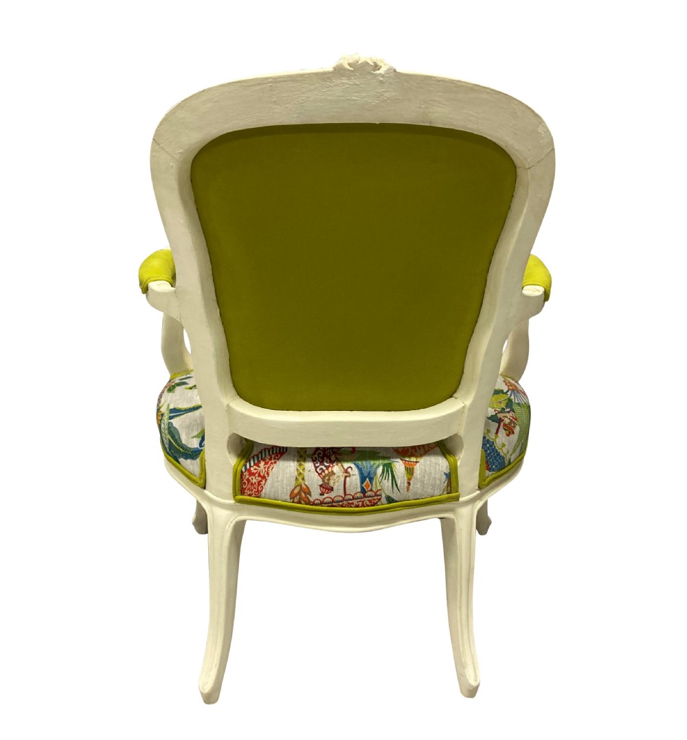 A pair of cream painted Louis XV style armchairs featuring carved cresting, cabriole legs, and upholstery with a monkey and palm tree pattern. View V