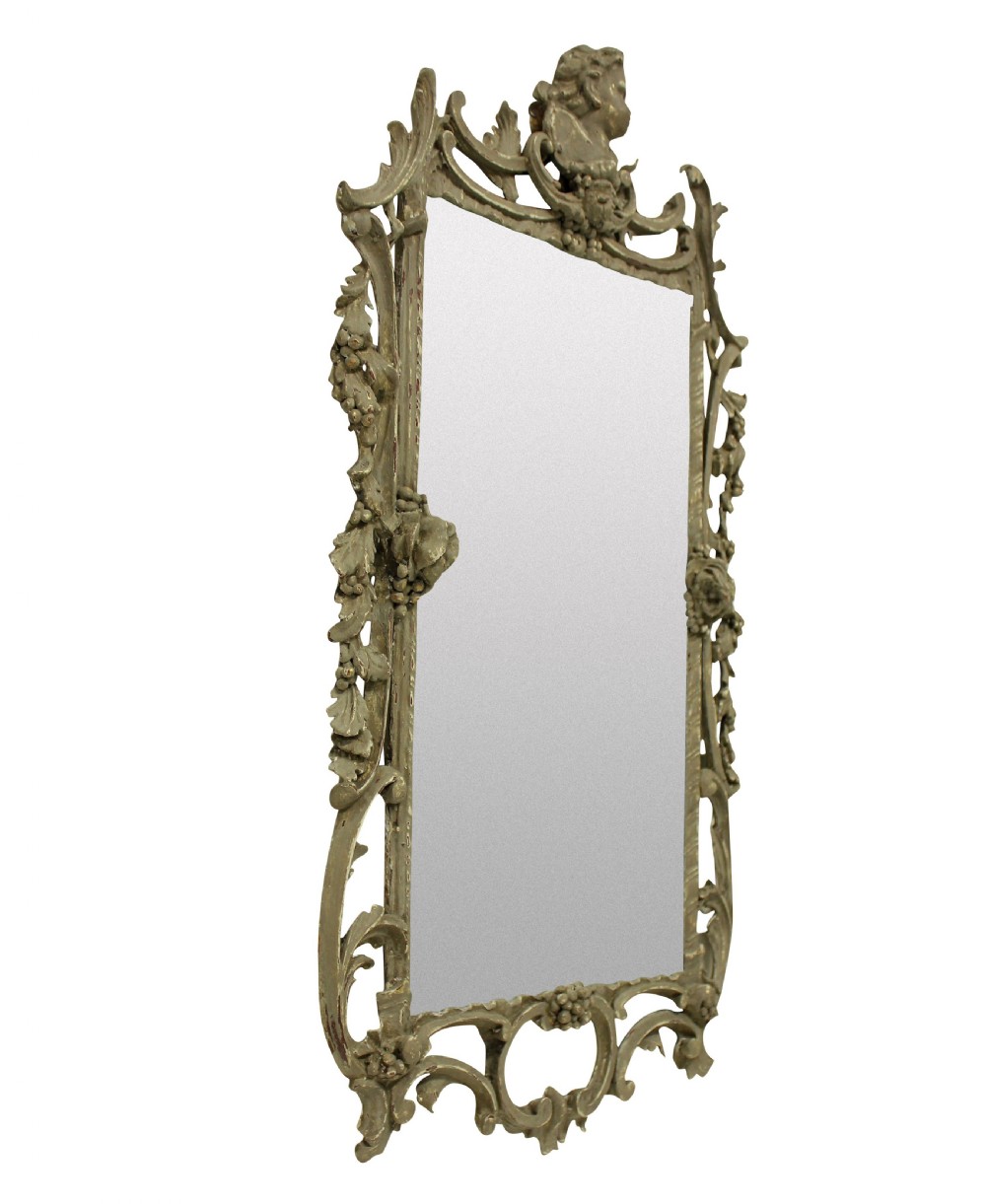 An ornate George III style rectangular wall mirror with a carved giltwood frame featuring a cherub crest, pierced acanthus scrolls, and grapevine motifs. View IV