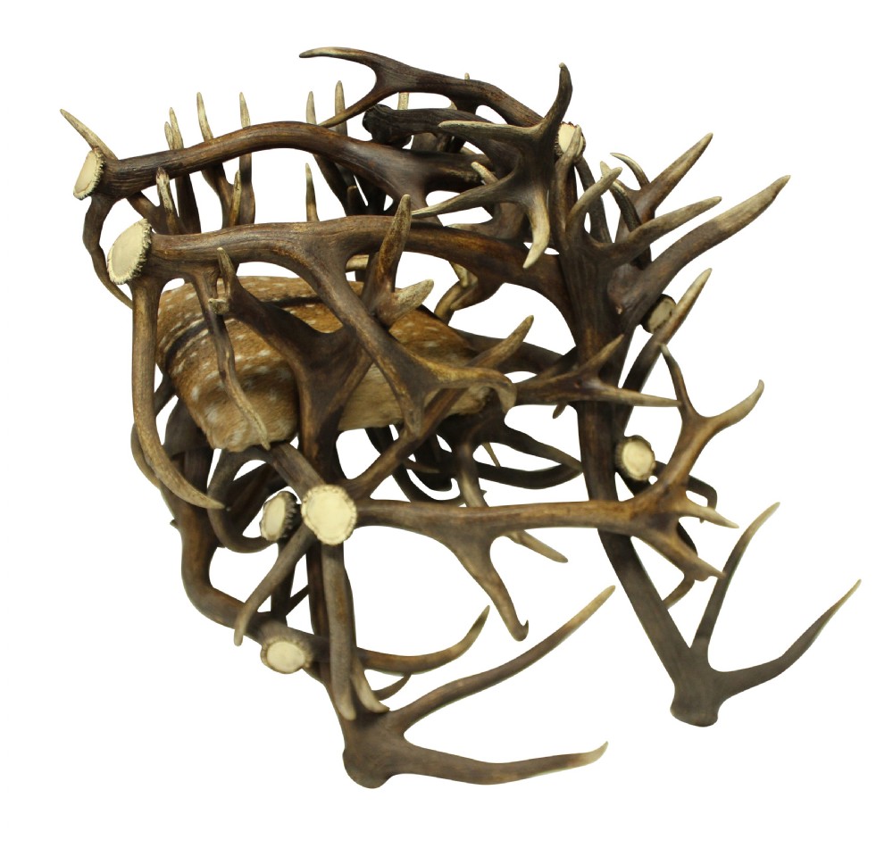 A pair of antique armchairs constructed from interwoven stag antlers with natural spotted hide seats. View III