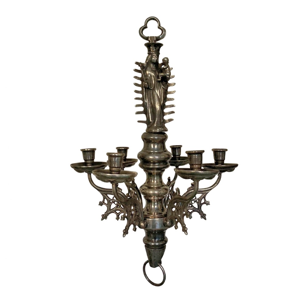 A silver-plated Flemish Gothic candle chandelier featuring a central Madonna and Child figure, baluster stem, and six scrolling arms with openwork tracery.