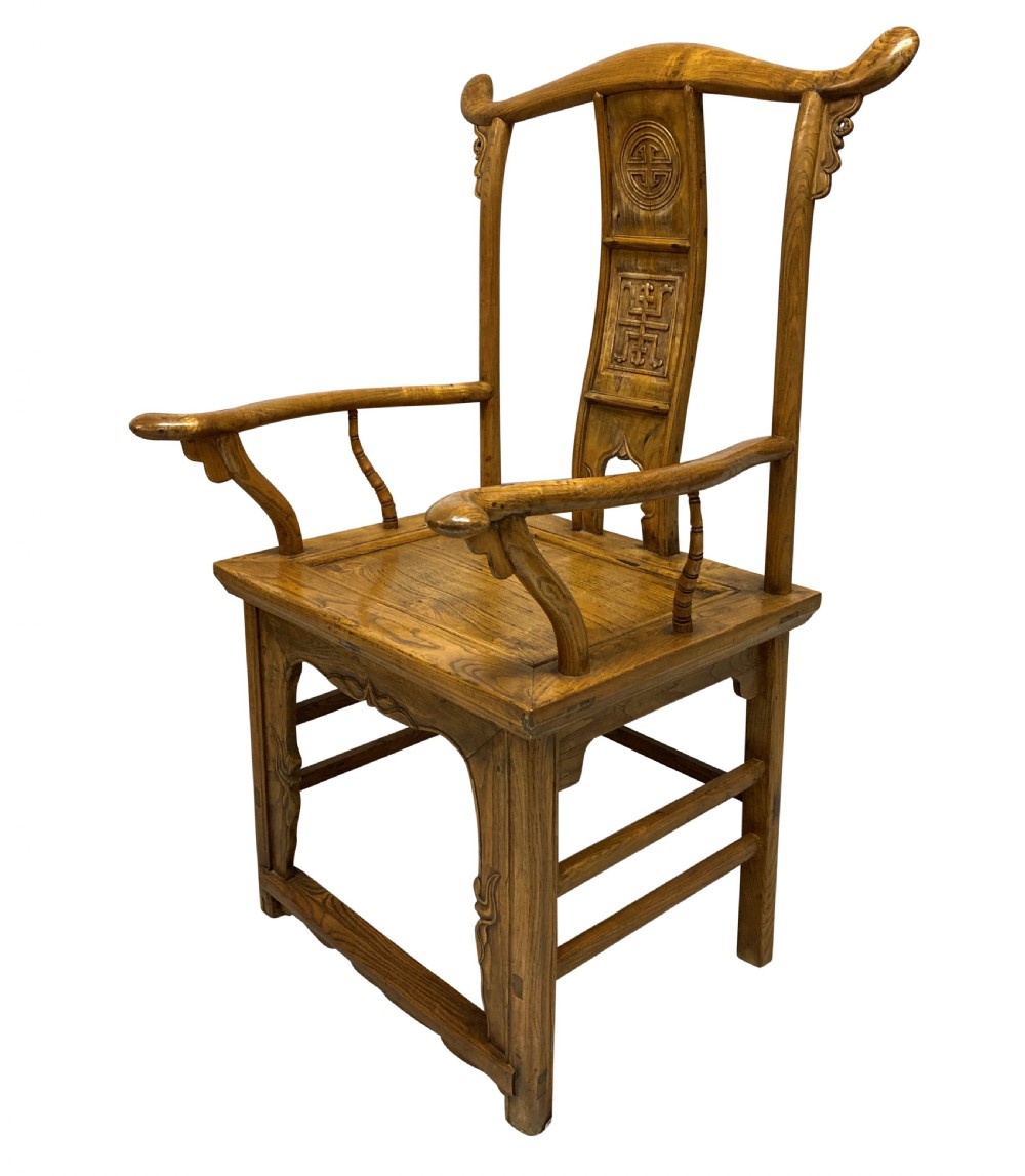 A pair of nineteenth-century Chinese elm yoke-back armchairs featuring carved central back splats and curved armrests. View VII