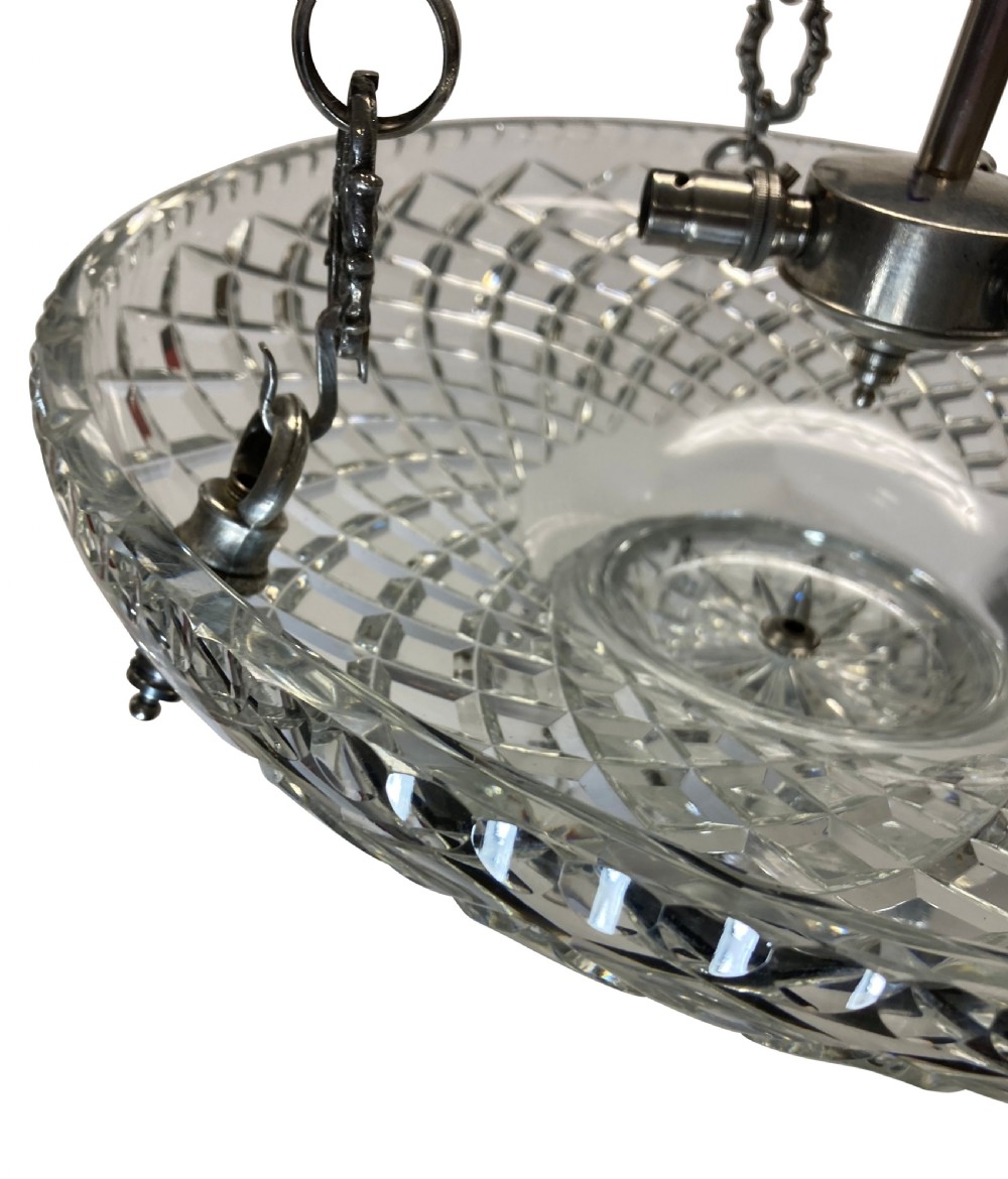 A nineteenth-century cut glass dish light featuring a diamond-patterned crystal bowl suspended by three silver-plated chains from a central rod. View II