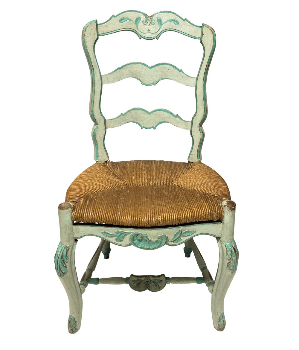 A set of four pale green painted Swedish dining chairs featuring carved wavy ladder backs, woven rush seats, and cabriole legs. View II