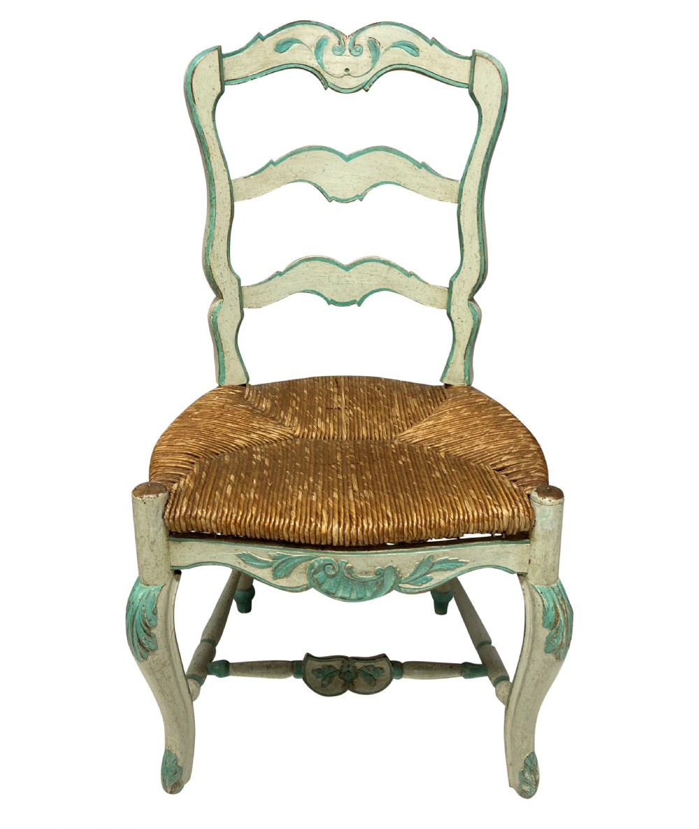 A set of four pale green painted Swedish dining chairs featuring carved wavy ladder backs, woven rush seats, and cabriole legs. View III