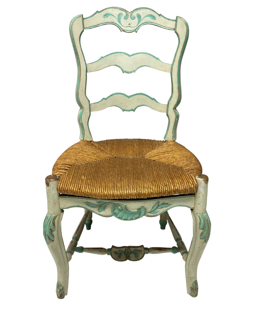 A set of four pale green painted Swedish dining chairs featuring carved wavy ladder backs, woven rush seats, and cabriole legs. View IV