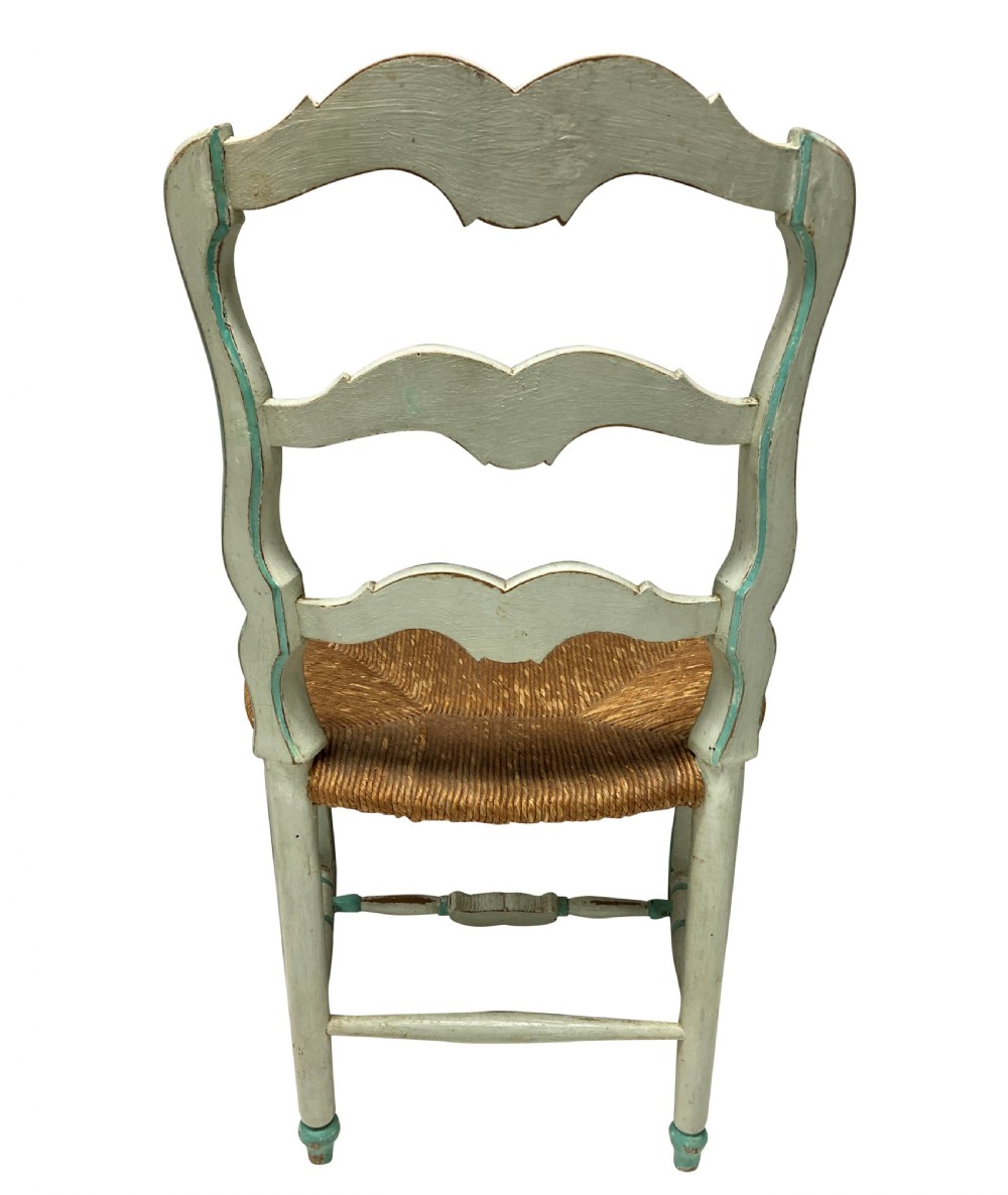 A set of four pale green painted Swedish dining chairs featuring carved wavy ladder backs, woven rush seats, and cabriole legs. View VIII