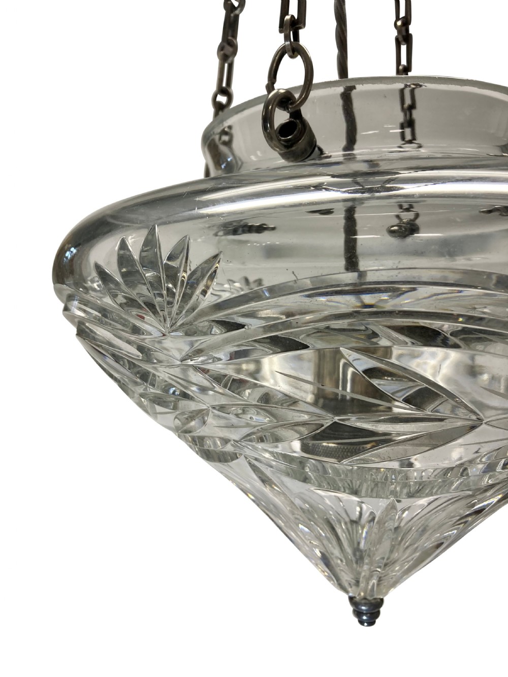 An Edwardian cut glass pendant light with starburst and geometric facets, suspended by three metal chains from a top gallery hook. View II