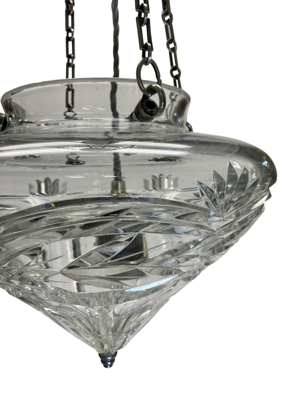 An Edwardian cut glass pendant light with starburst and geometric facets, suspended by three metal chains from a top gallery hook. View III