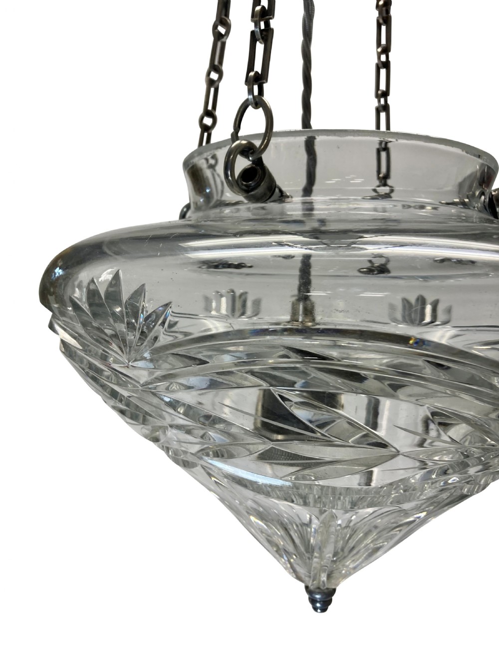 An Edwardian cut glass pendant light with starburst and geometric facets, suspended by three metal chains from a top gallery hook. View V