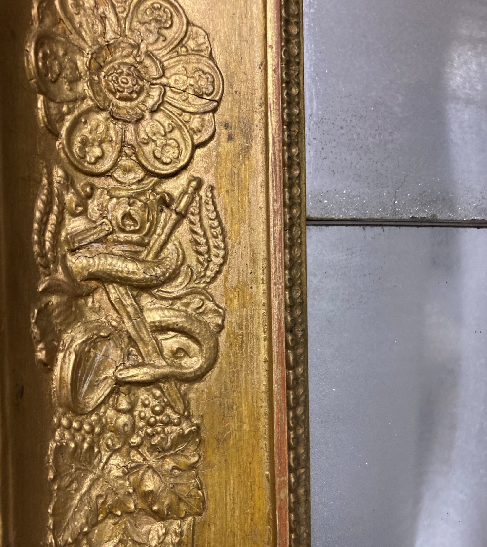 A large rectangular French Napoleon III giltwood mirror featuring relief floral carvings along the frame and a horizontal split glass plate. View VI