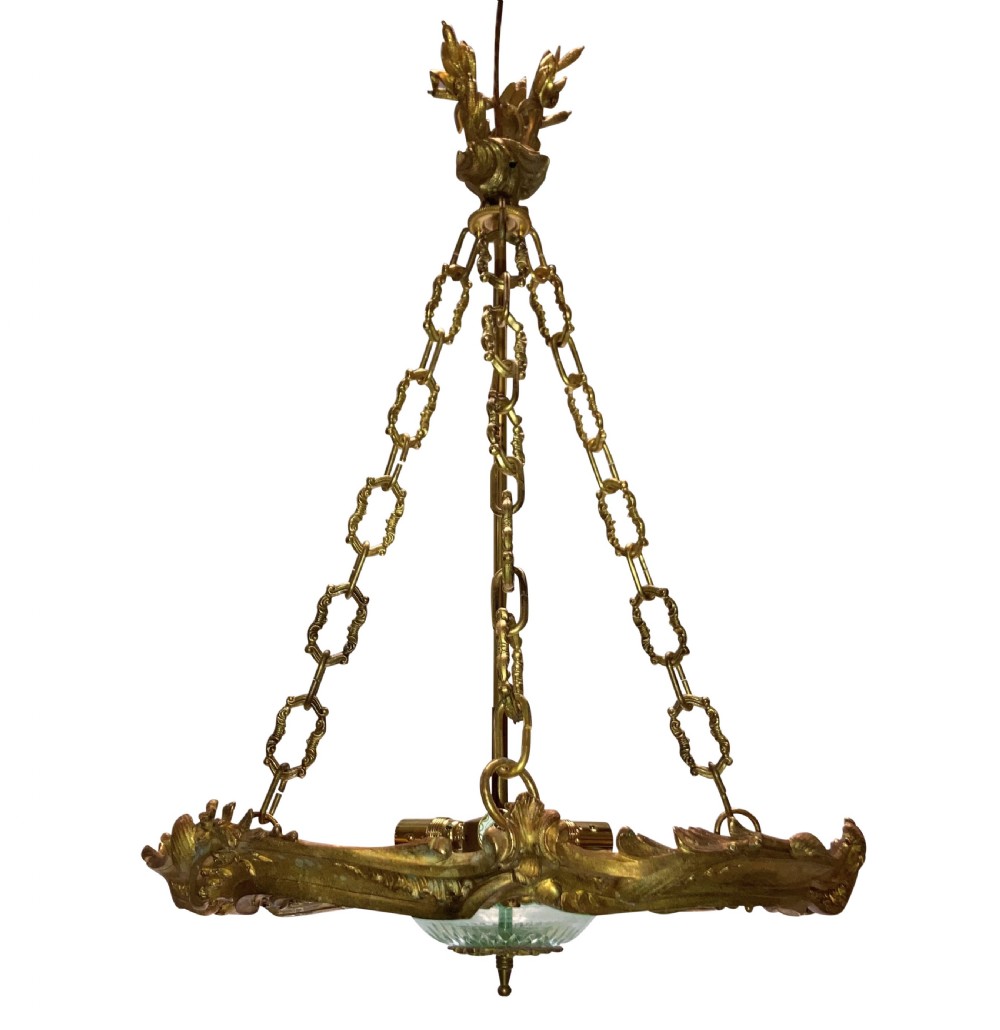 A French Rococo style light fixture featuring a gold-toned ormolu frame with scrolling foliate designs surrounding a central cut-glass bowl suspended by three decorative metal chains. View II