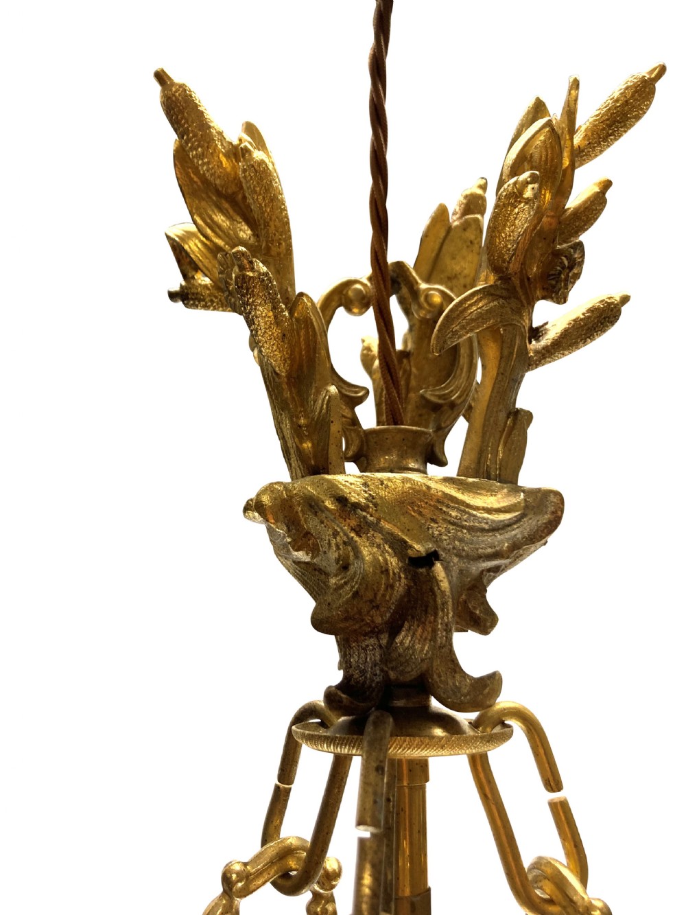 A French Rococo style light fixture featuring a gold-toned ormolu frame with scrolling foliate designs surrounding a central cut-glass bowl suspended by three decorative metal chains. View V