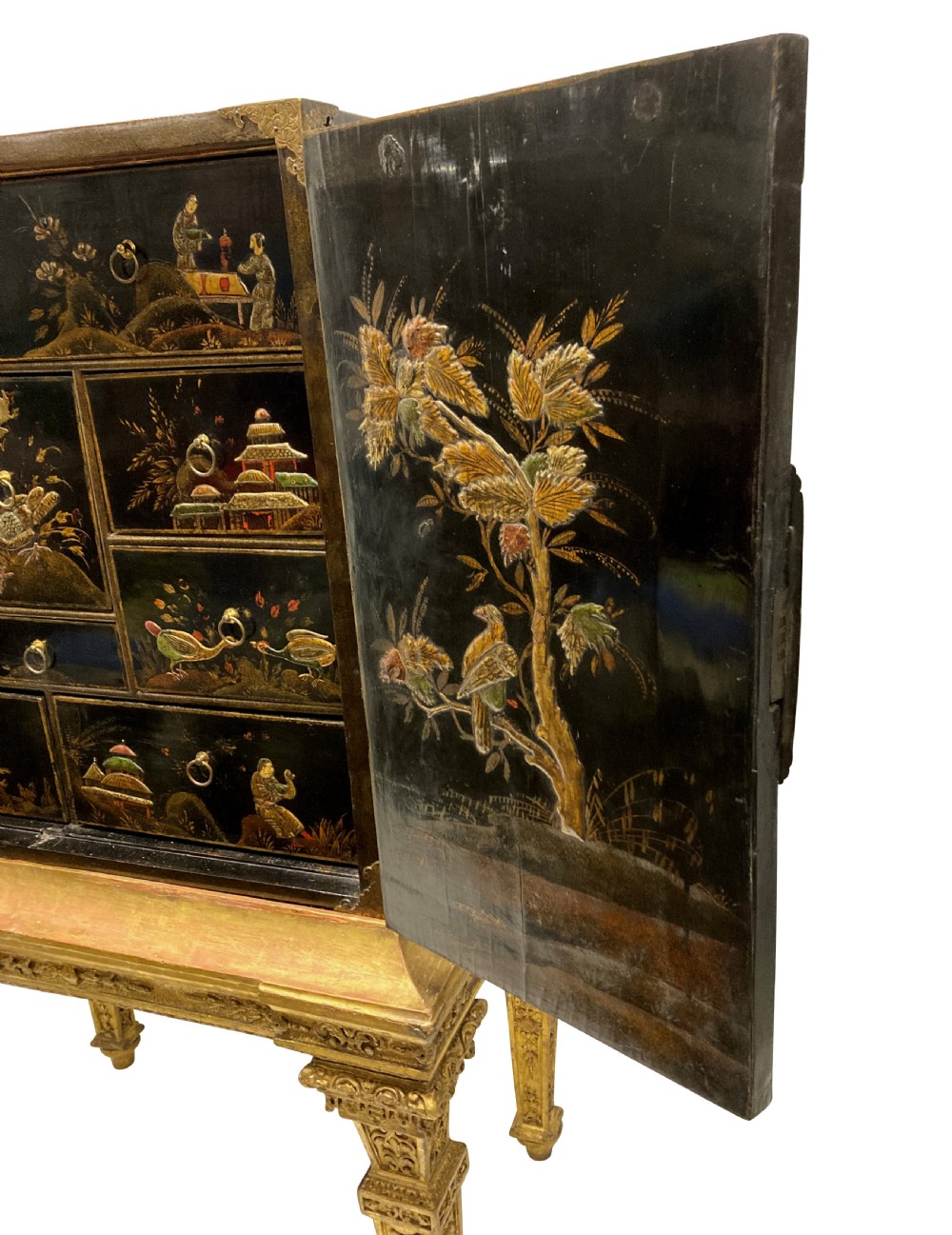 A two-door black japanned cabinet decorated with gold Chinoiserie scenes resting on a carved gilded wooden stand. View VI