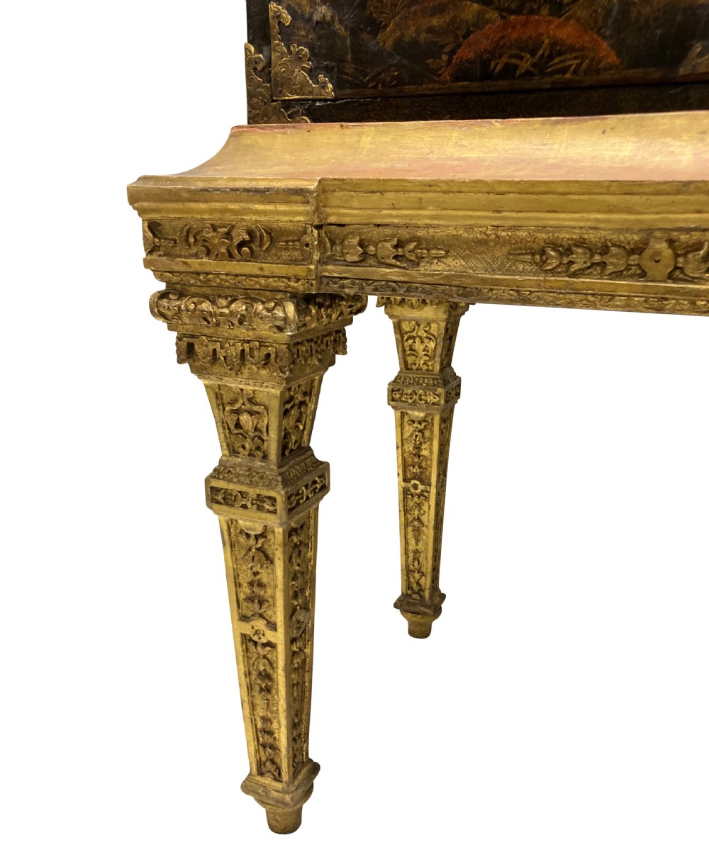 A two-door black japanned cabinet decorated with gold Chinoiserie scenes resting on a carved gilded wooden stand. View VIII