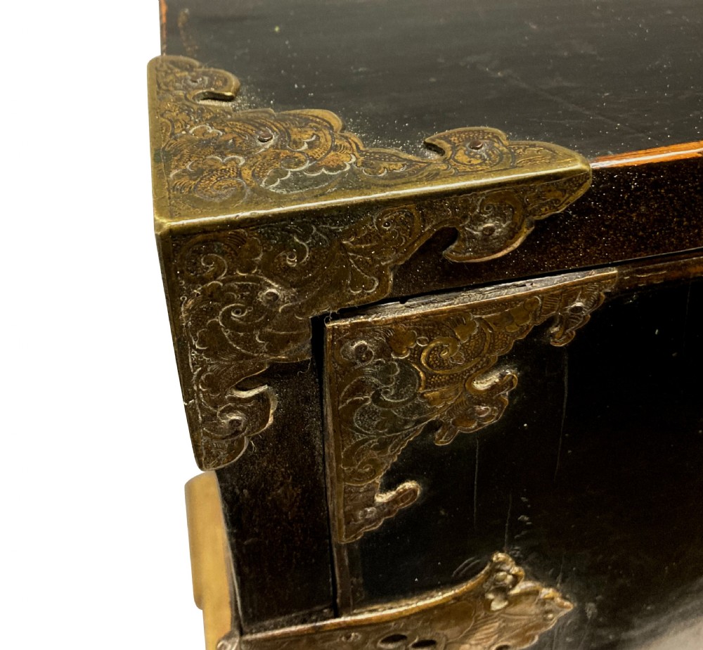 A two-door black japanned cabinet decorated with gold Chinoiserie scenes resting on a carved gilded wooden stand. View XIII