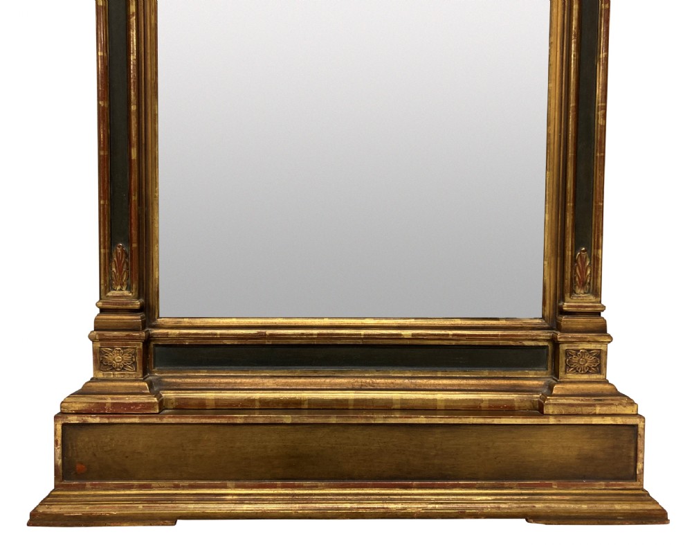 An Italian Renaissance giltwood tabernacle wall mirror featuring carved side pilasters, dark painted panels, and a cresting pediment with a central shell motif. View V