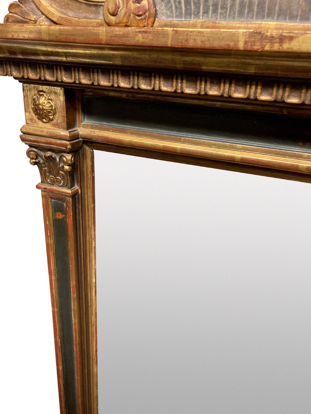 An Italian Renaissance giltwood tabernacle wall mirror featuring carved side pilasters, dark painted panels, and a cresting pediment with a central shell motif. View VI