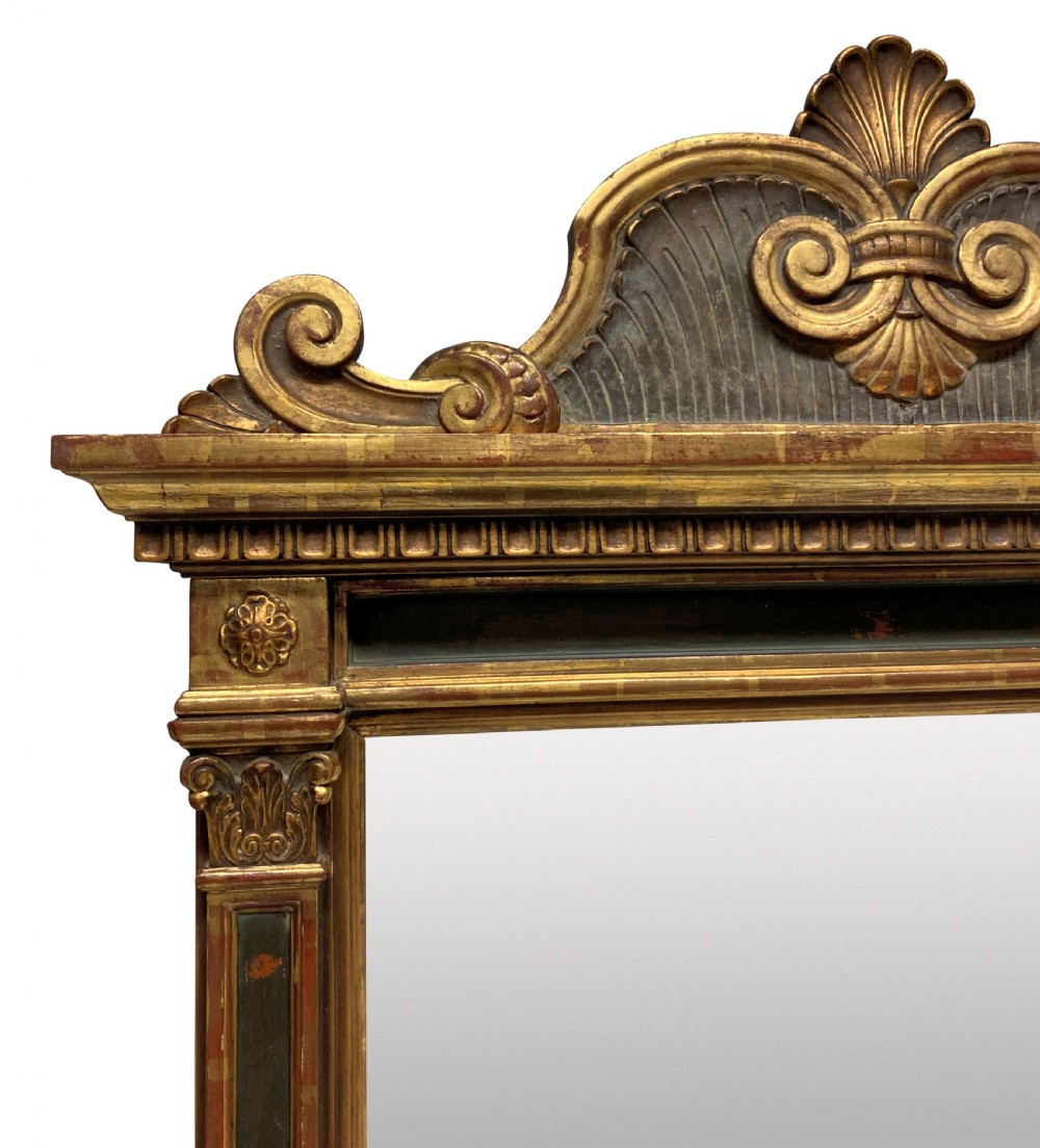 An Italian Renaissance giltwood tabernacle wall mirror featuring carved side pilasters, dark painted panels, and a cresting pediment with a central shell motif. View VII