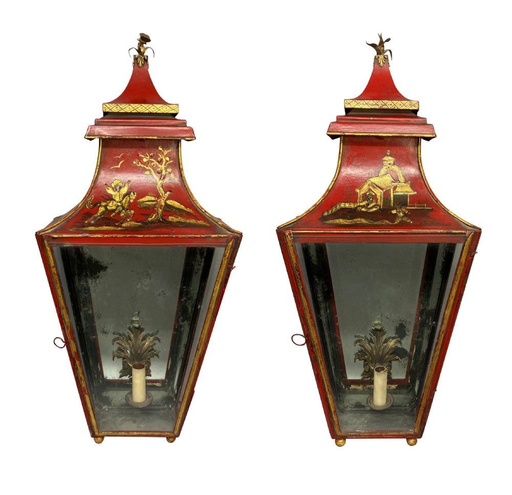 A pair of Regency style wall lanterns finished in scarlet red japanning with hand-painted gold chinoiserie motifs and pagoda tops.
