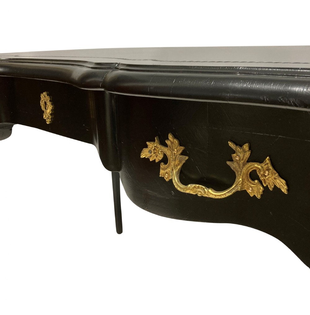 A Louis XV style black lacquered writing table with cabriole legs, an inset leather surface, and ornate gilt bronze corner mounts. View II