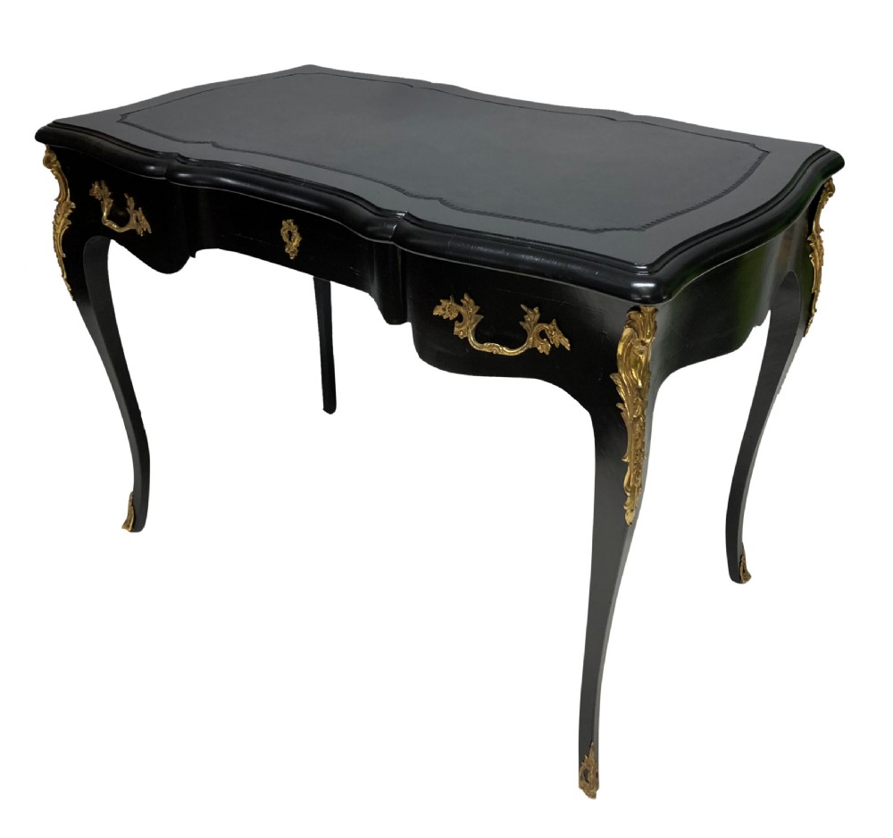 A Louis XV style black lacquered writing table with cabriole legs, an inset leather surface, and ornate gilt bronze corner mounts. View VII