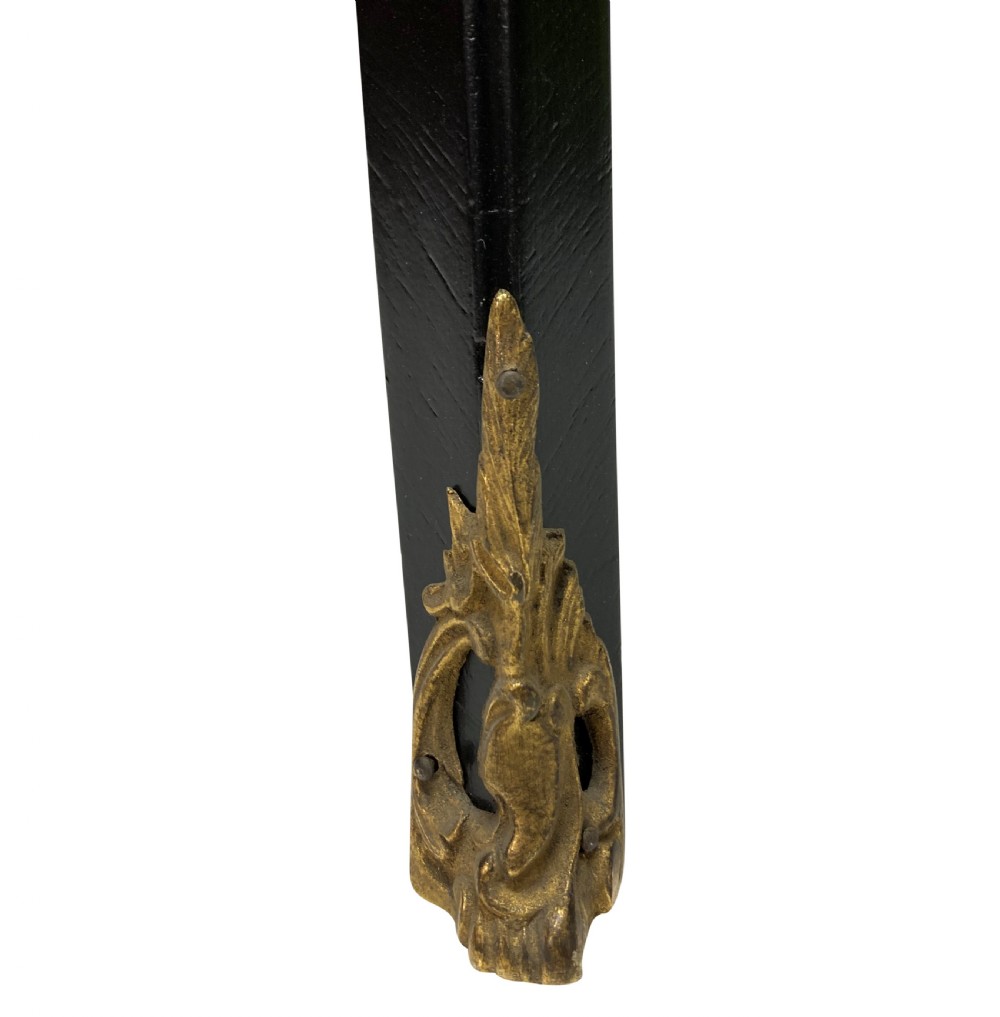 A Louis XV style black lacquered writing table with cabriole legs, an inset leather surface, and ornate gilt bronze corner mounts. View X