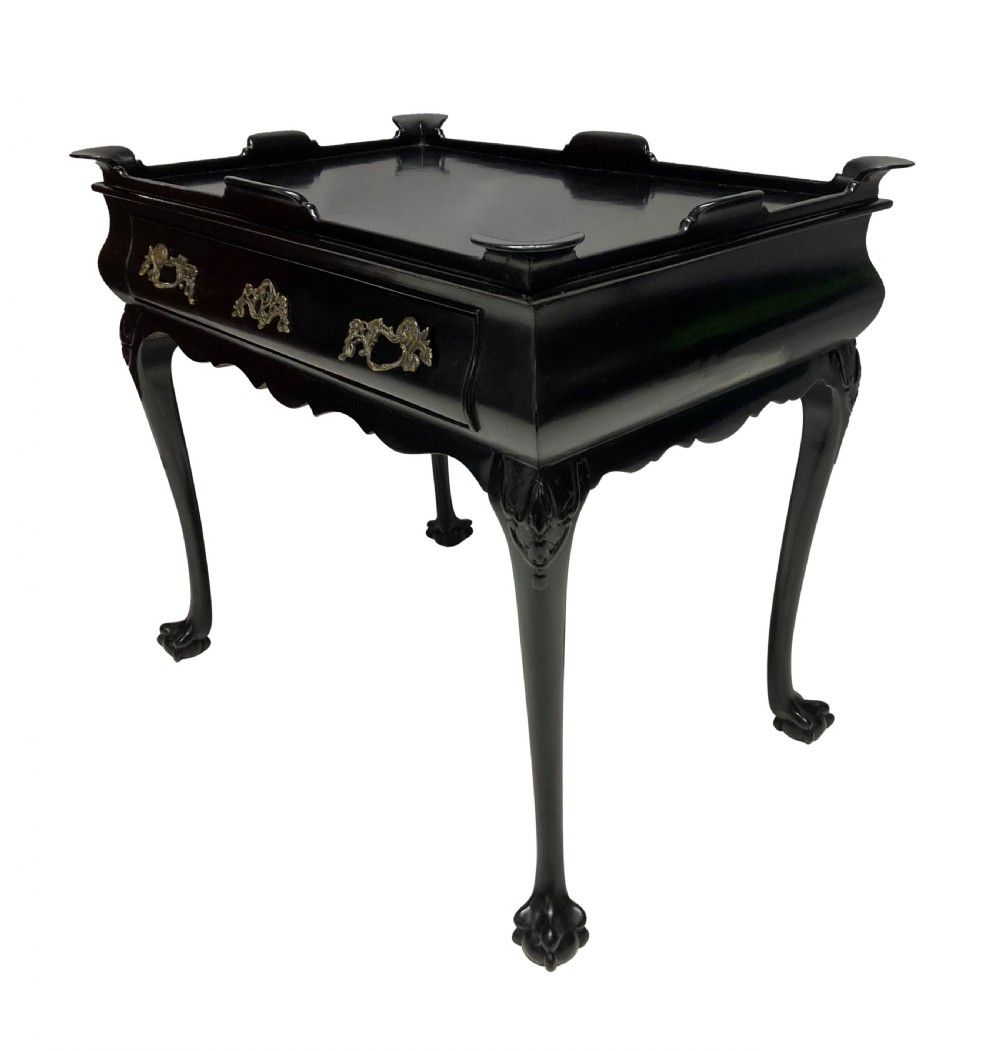 A black lacquered walnut silver table featuring a raised gallery top, a single drawer with brass handles, and cabriole legs with claw and ball feet. View V