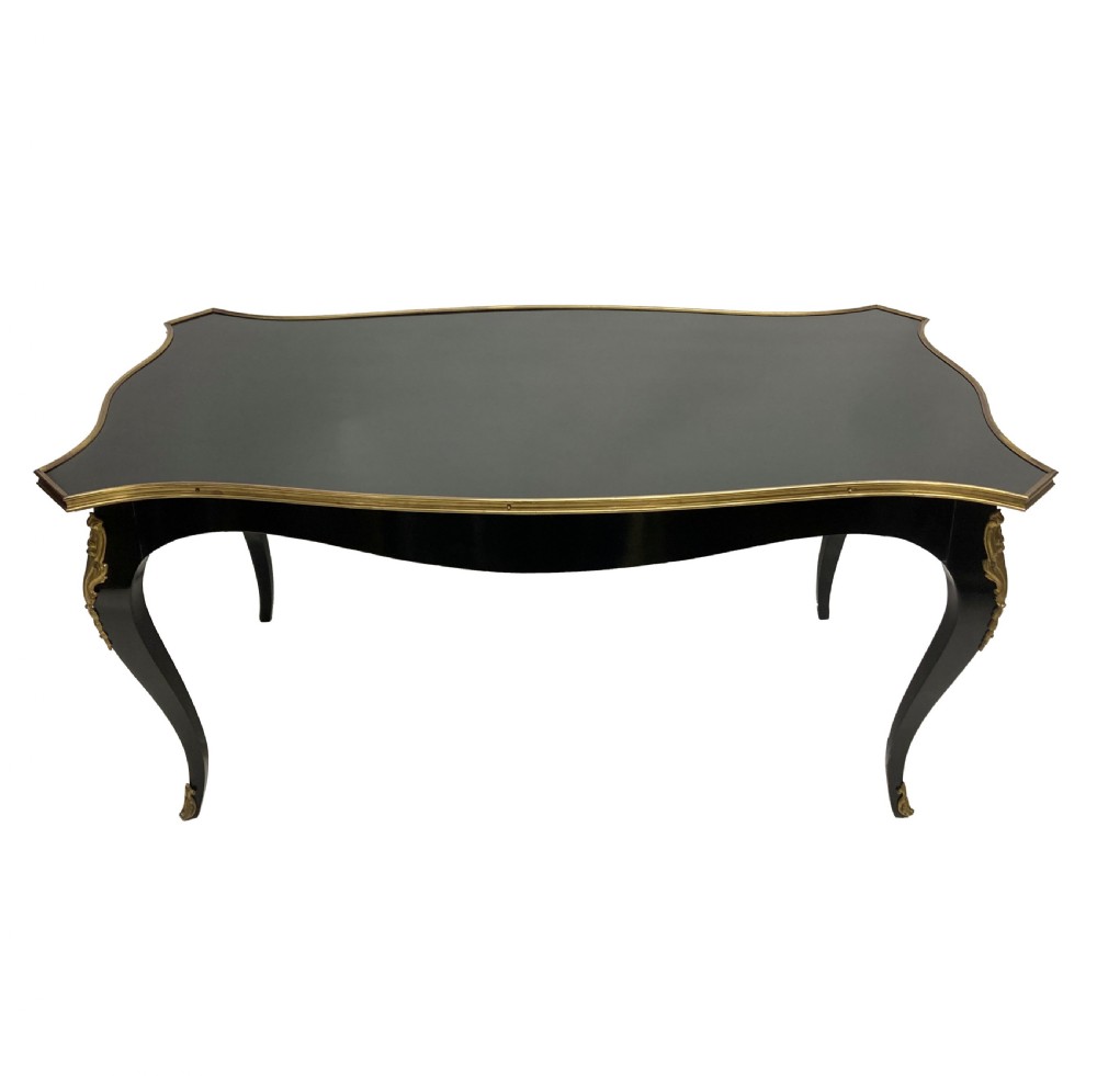 A low black lacquered Louis XV style occasional table with serpentine edges, gilt metal moulding, and cabriole legs with ormolu mounts.