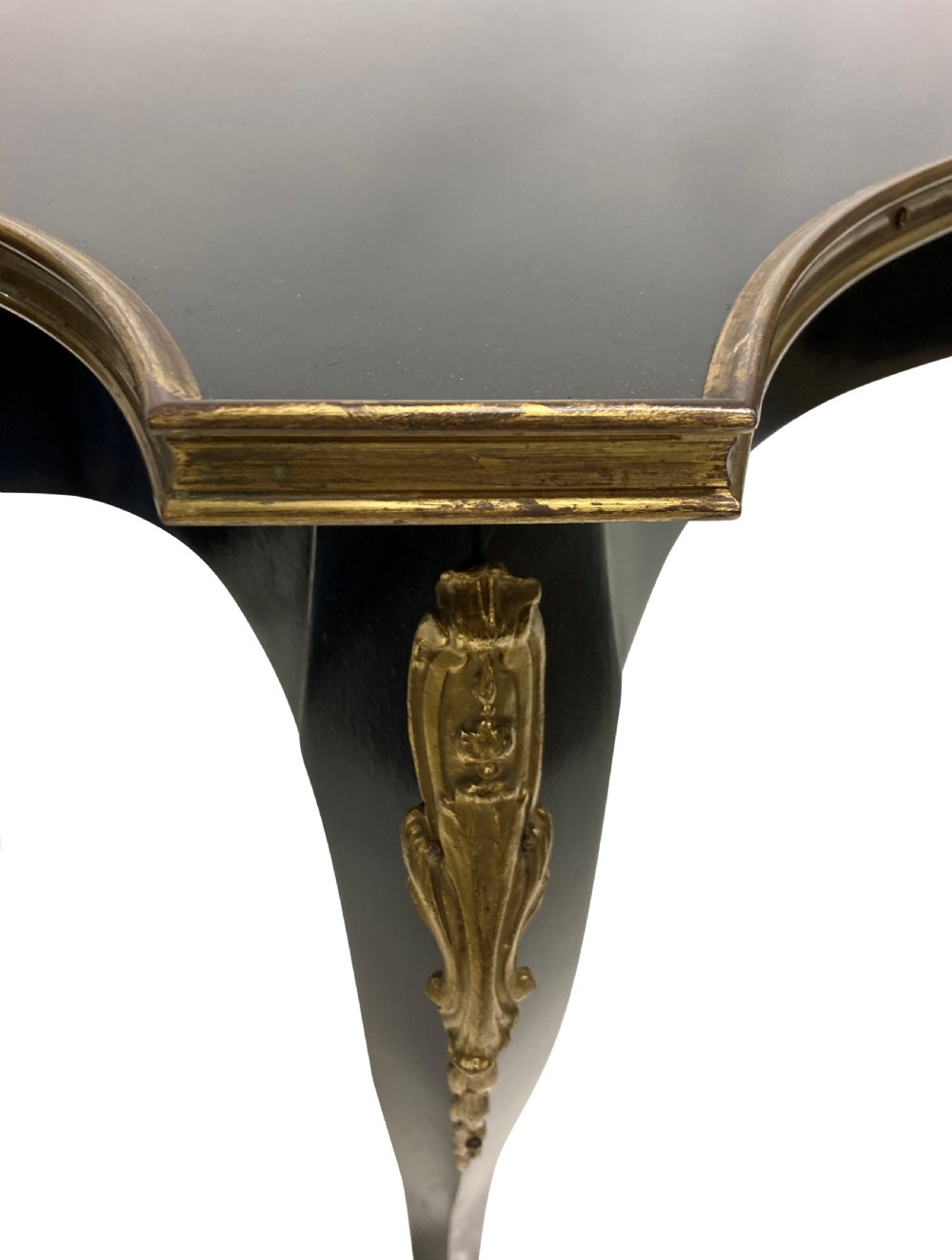 A low black lacquered Louis XV style occasional table with serpentine edges, gilt metal moulding, and cabriole legs with ormolu mounts. View II
