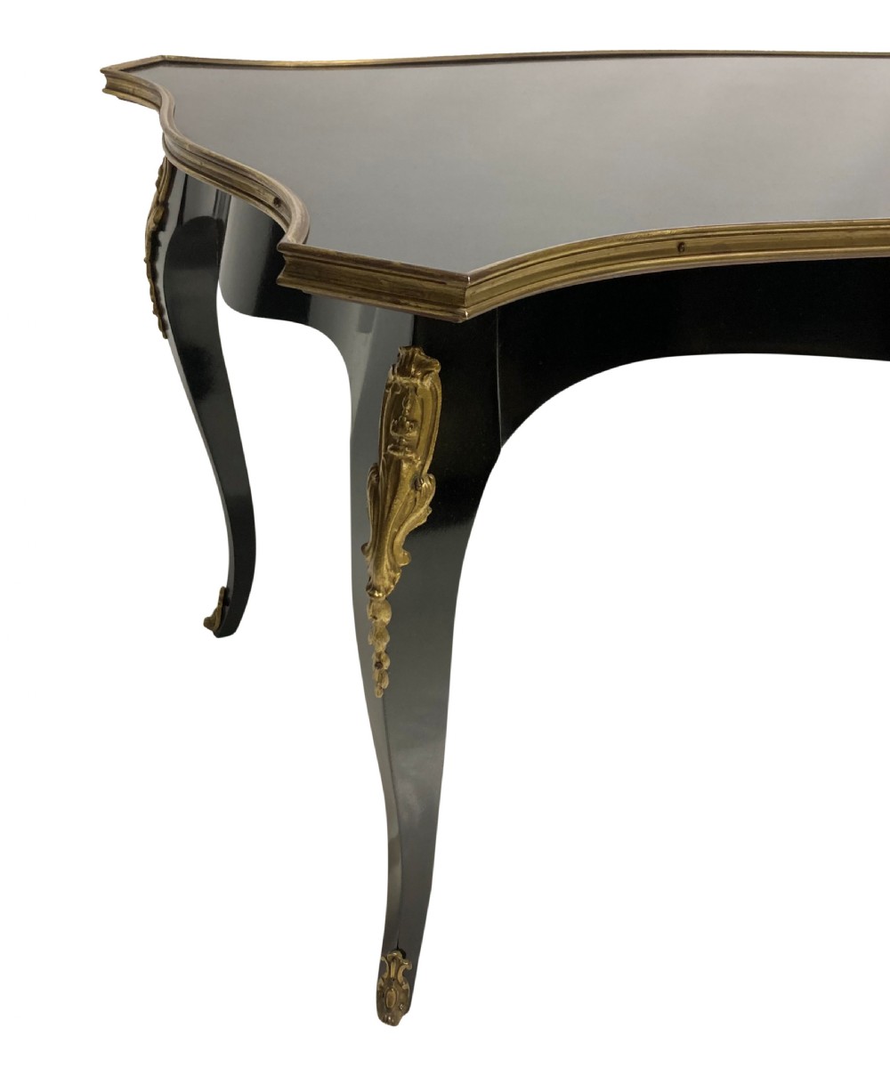 A low black lacquered Louis XV style occasional table with serpentine edges, gilt metal moulding, and cabriole legs with ormolu mounts. View IV