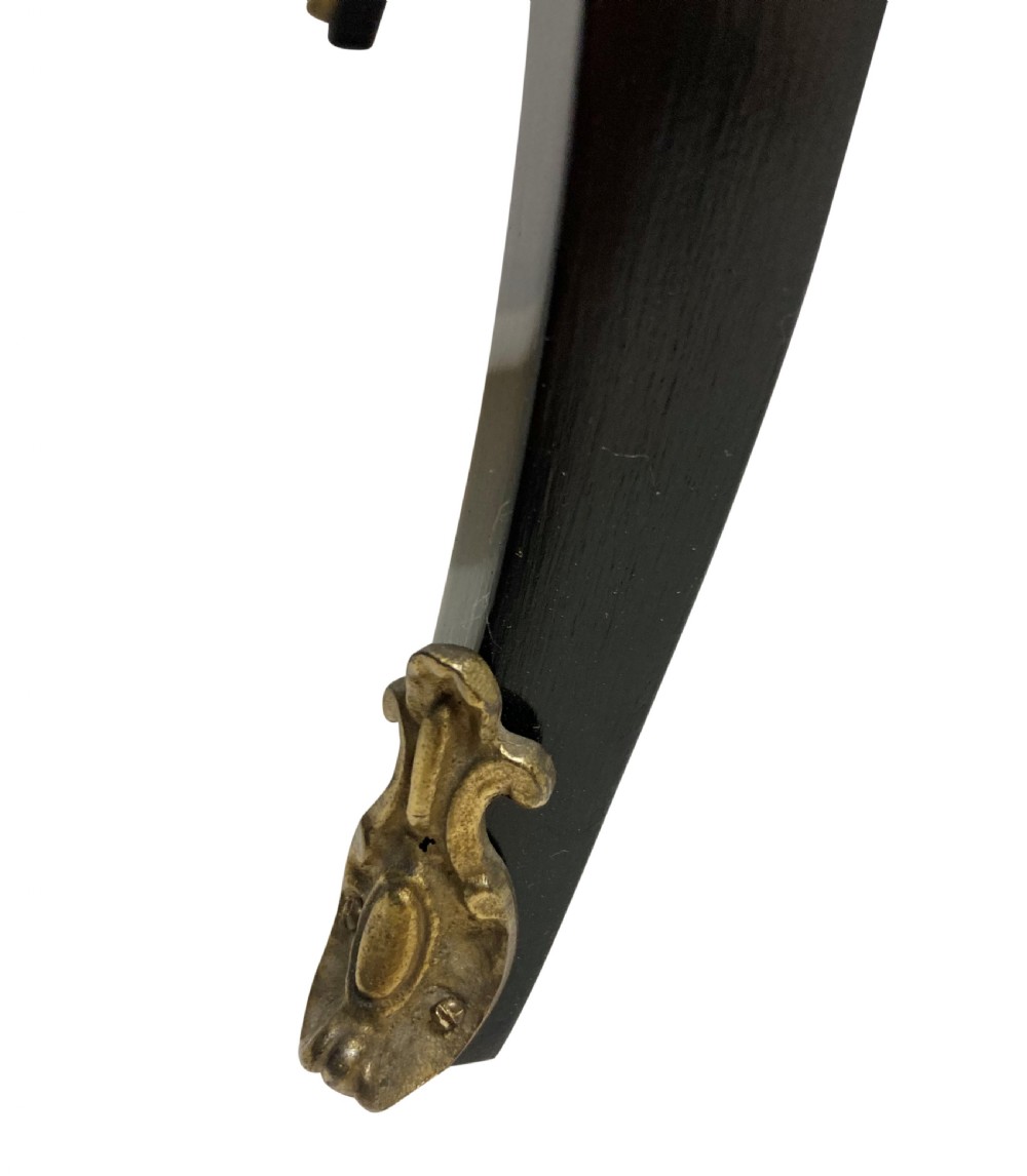 A low black lacquered Louis XV style occasional table with serpentine edges, gilt metal moulding, and cabriole legs with ormolu mounts. View V