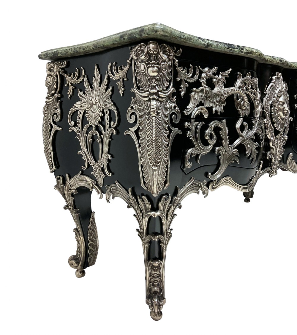A French Rococo style black lacquered commode featuring a green marble top and elaborate silver-coloured ornamental mounts. View III
