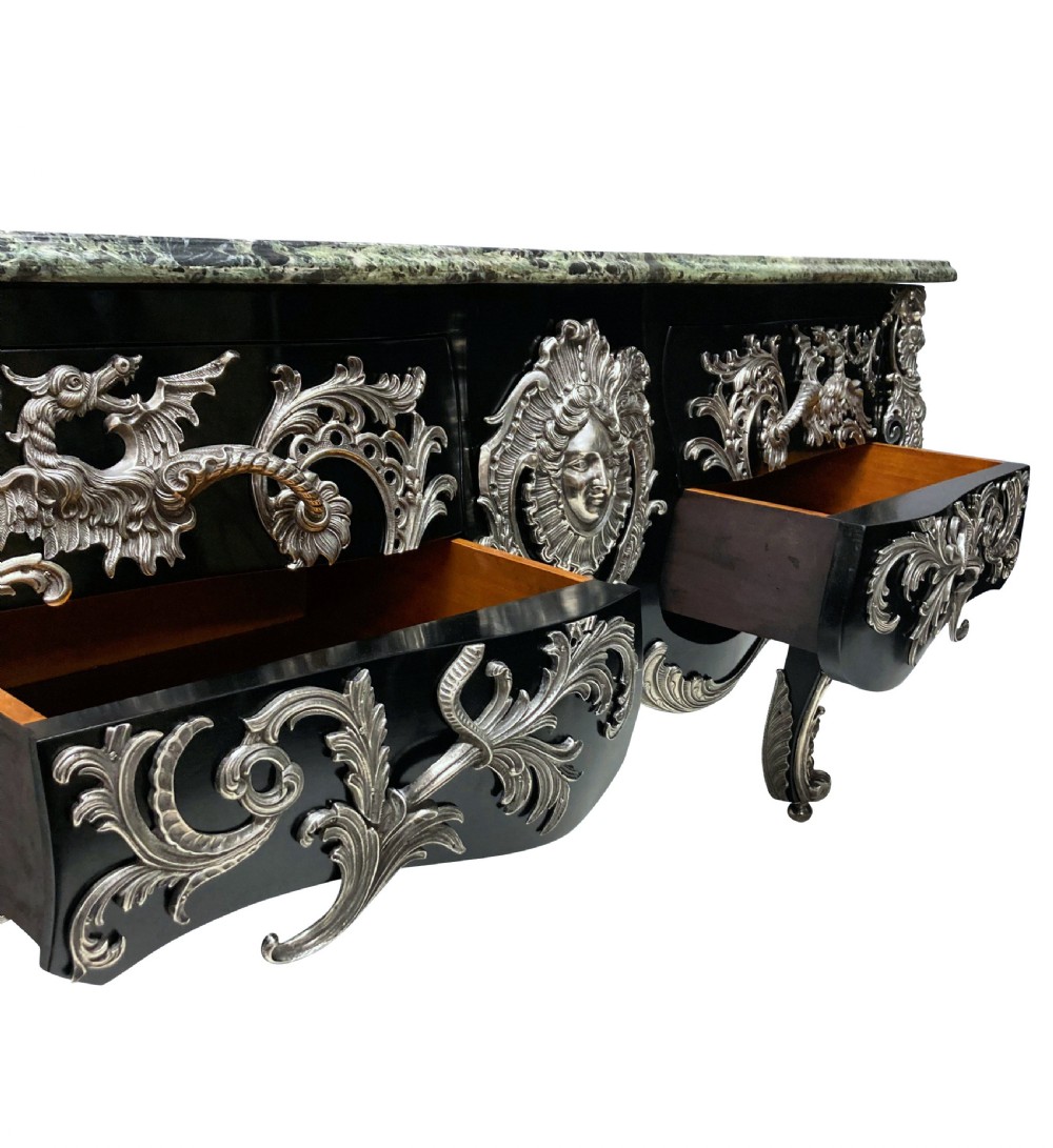 A French Rococo style black lacquered commode featuring a green marble top and elaborate silver-coloured ornamental mounts. View V