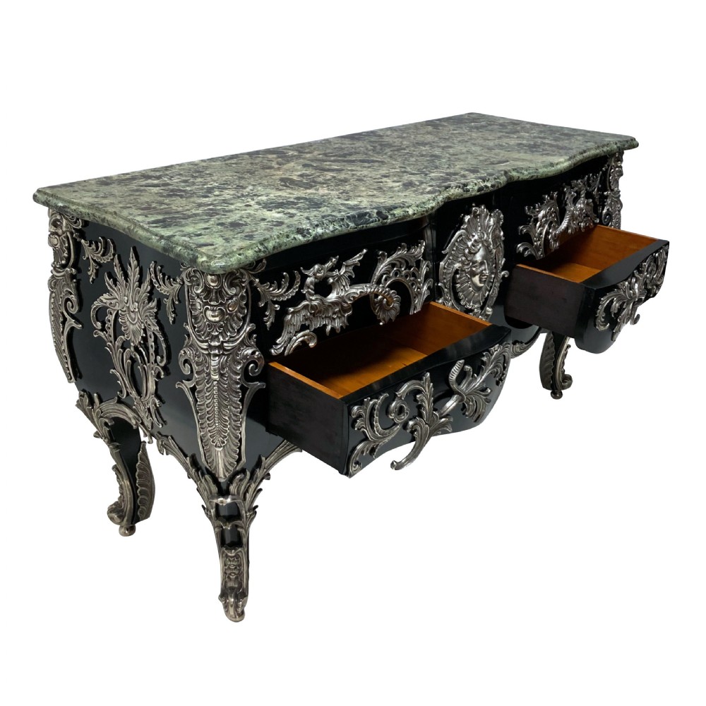 A French Rococo style black lacquered commode featuring a green marble top and elaborate silver-coloured ornamental mounts. View VI