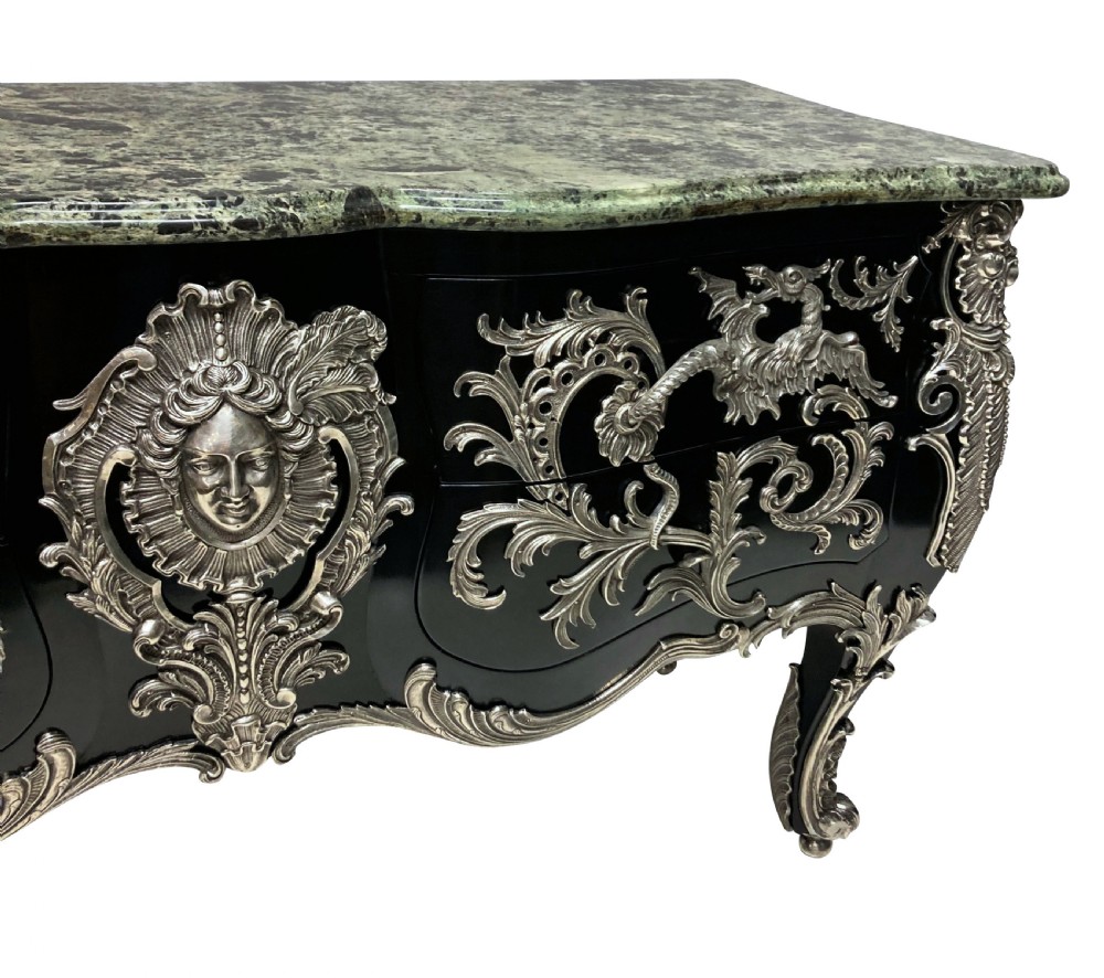 A French Rococo style black lacquered commode featuring a green marble top and elaborate silver-coloured ornamental mounts. View VII