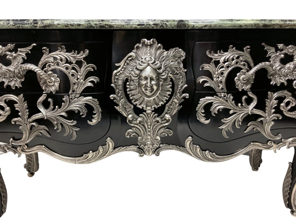 A French Rococo style black lacquered commode featuring a green marble top and elaborate silver-coloured ornamental mounts. View VIII