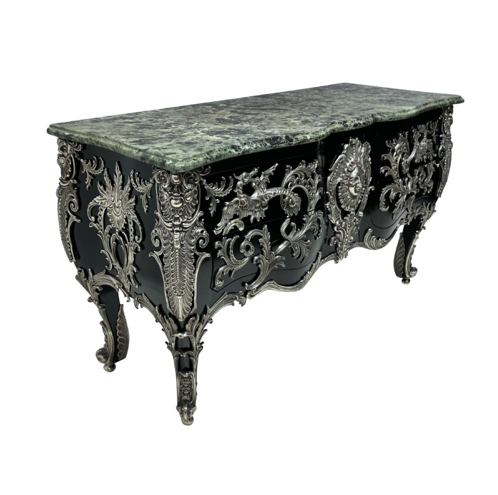 A French Rococo style black lacquered commode featuring a green marble top and elaborate silver-coloured ornamental mounts. View XI
