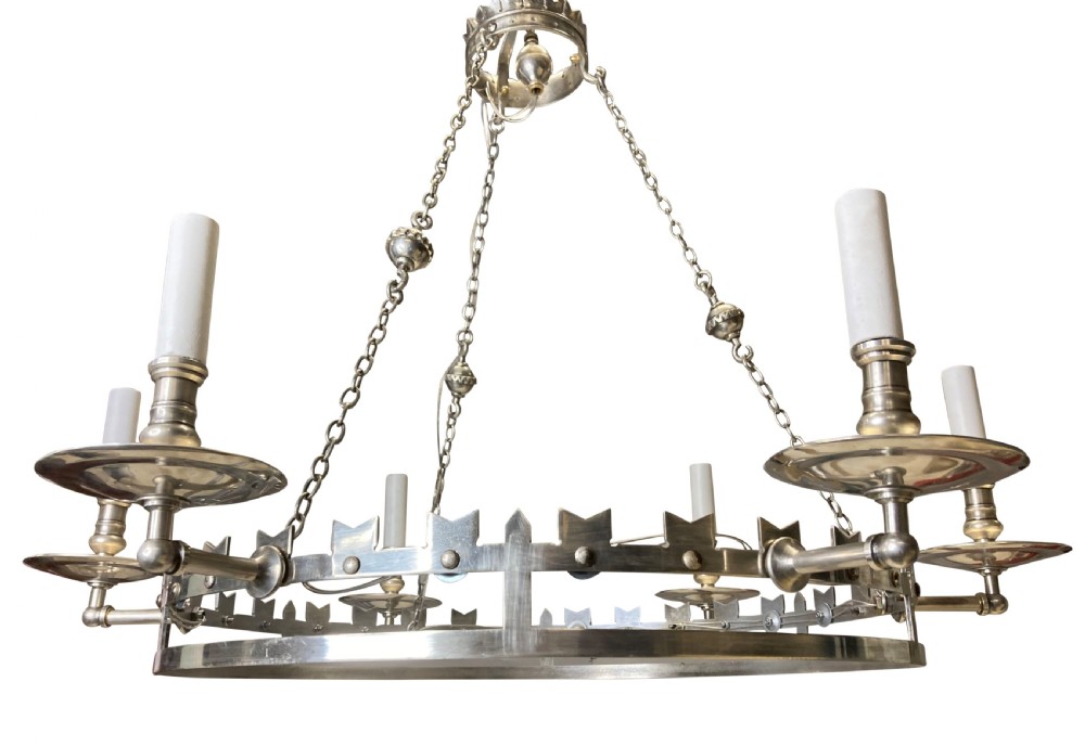 A circular silver-plated Gothic corona light fixture featuring a castellated upper rim, multiple candle-style light holders, and suspension chains leading to a crown-shaped ceiling rose. View II