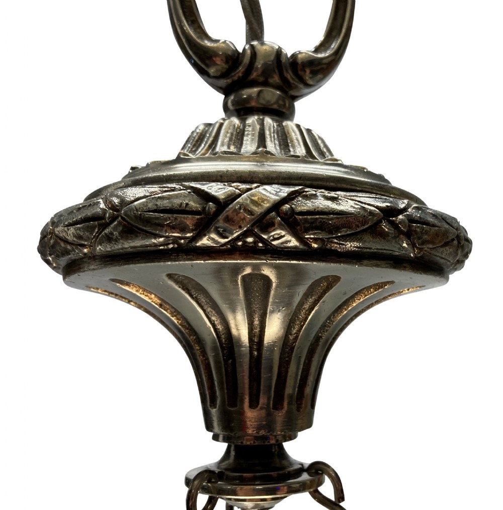 An Edwardian pendant light featuring a fluted clear cut glass bowl suspended by three silver-plated chains from a cast ceiling fitting. View VII