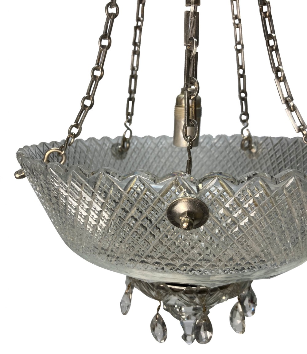 An Edwardian hanging dish light featuring diamond-cut clear glass suspended by metal chains with crystal drop prisms at the base. View IV