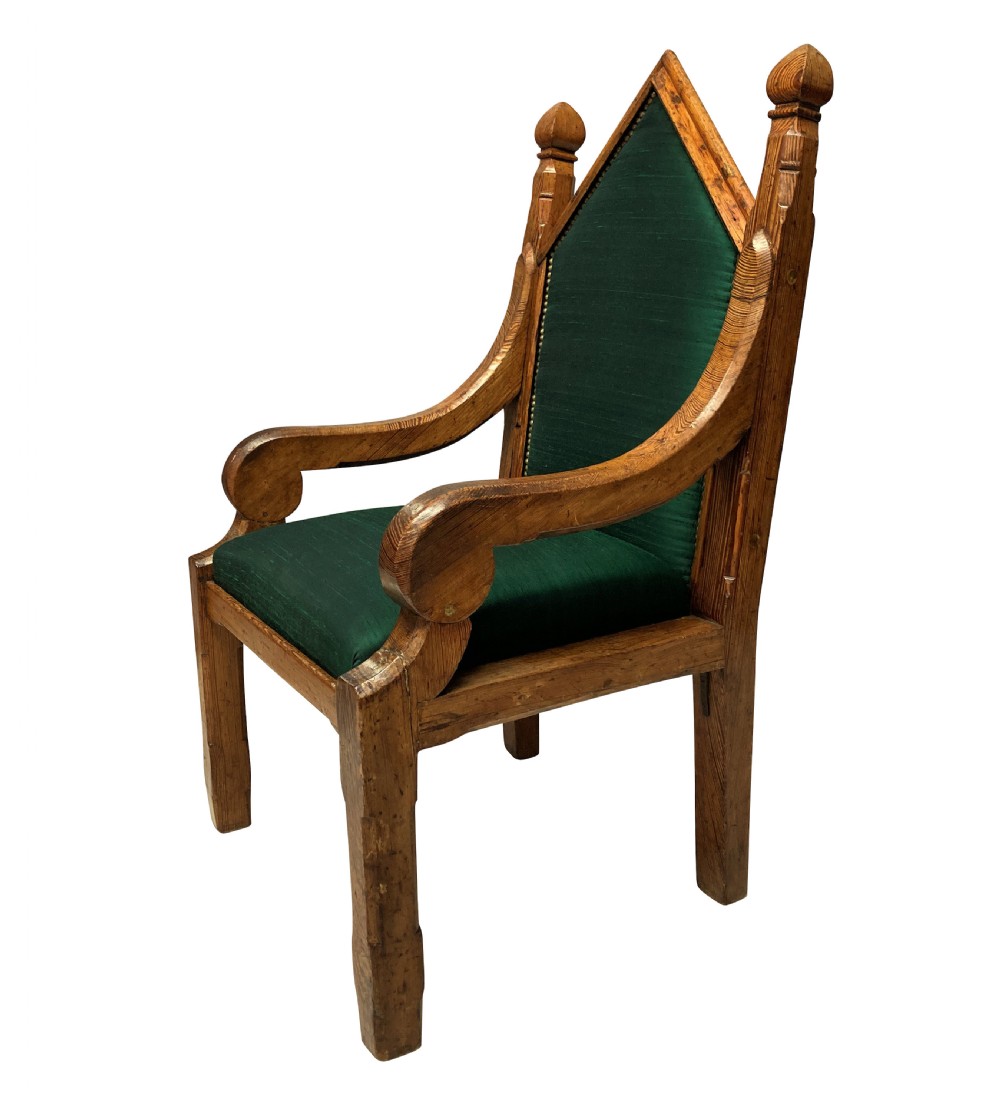 An English Gothic Revival oak armchair featuring a pointed arched backrest upholstered in green fabric with brass stud trimming. View II