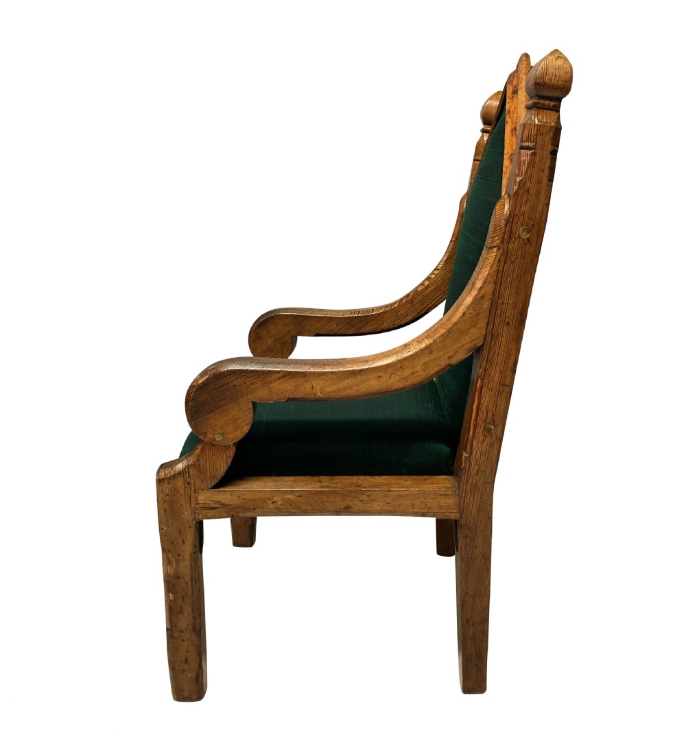 An English Gothic Revival oak armchair featuring a pointed arched backrest upholstered in green fabric with brass stud trimming. View III
