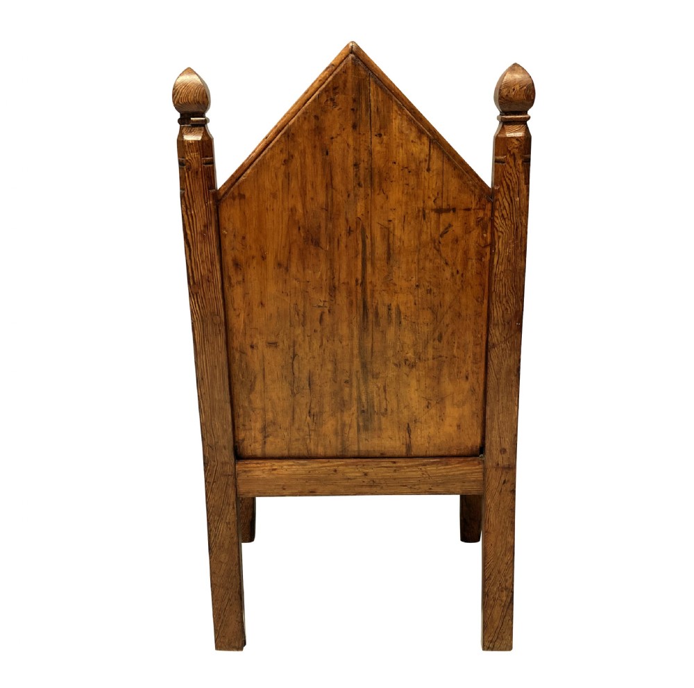 An English Gothic Revival oak armchair featuring a pointed arched backrest upholstered in green fabric with brass stud trimming. View IV