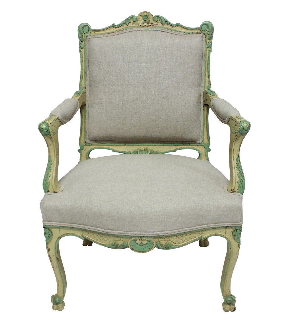 A pair of 1930s Louis XV style open armchairs with distressed cream and green painted wooden frames and neutral linen upholstery. View II