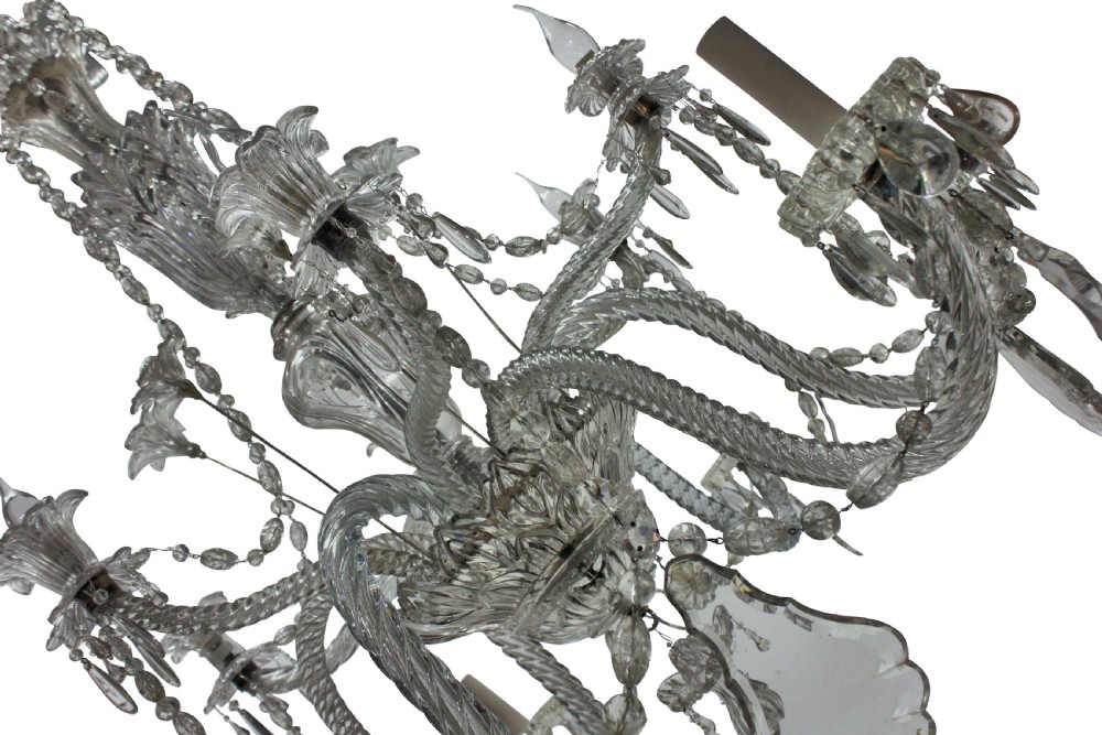 A large French twelve-arm clear cut-crystal chandelier featuring twisted glass arms, cascading crystal drops, and candle-style bulb holders. View III