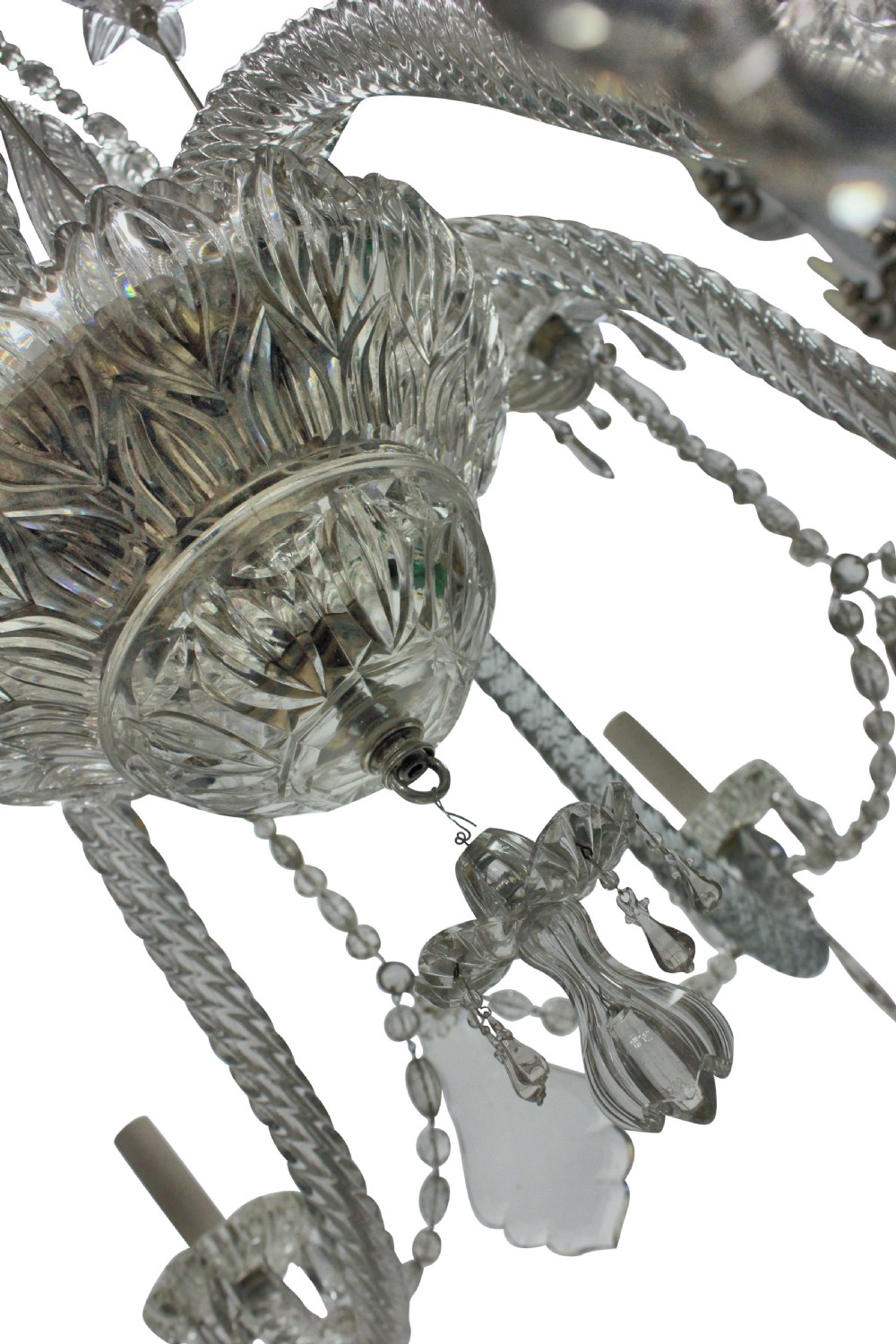 A large French twelve-arm clear cut-crystal chandelier featuring twisted glass arms, cascading crystal drops, and candle-style bulb holders. View IV
